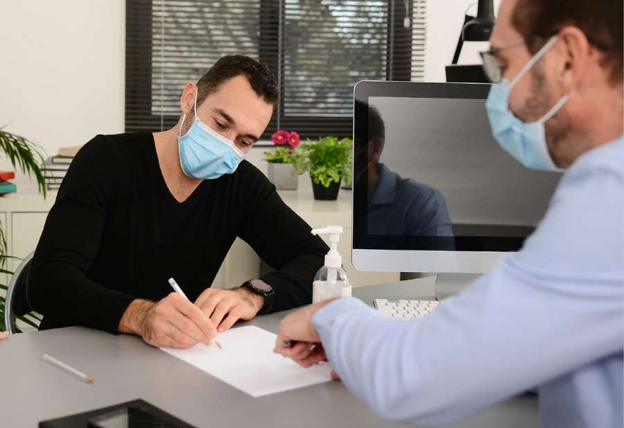 Man filling out paperwork at the doctor's office