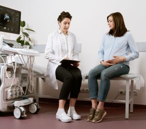 pregnant woman at doctor - photo by mart production